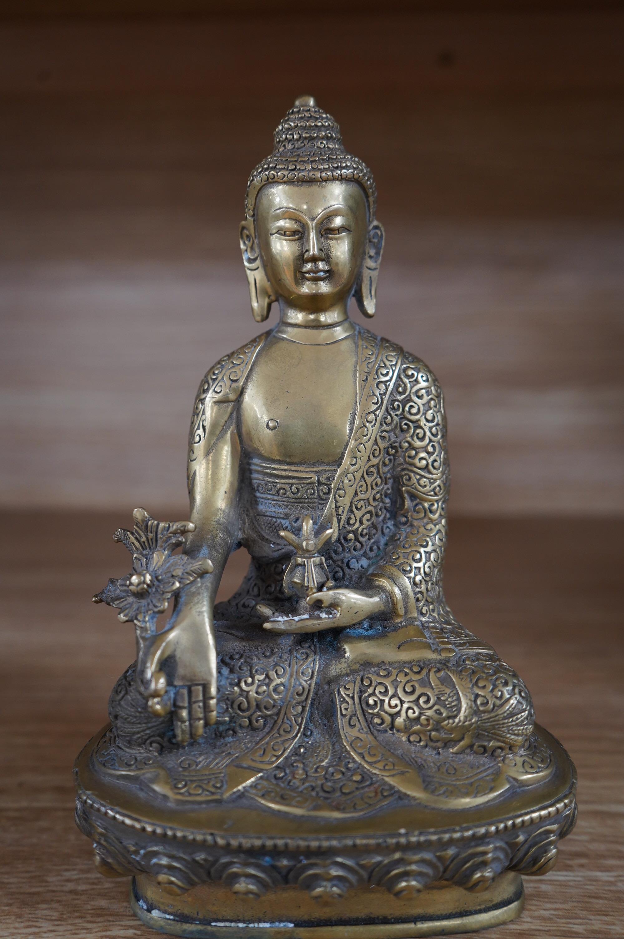 A Tibetan bronze model of a seated Buddha, 19cm. Condition - fair to good